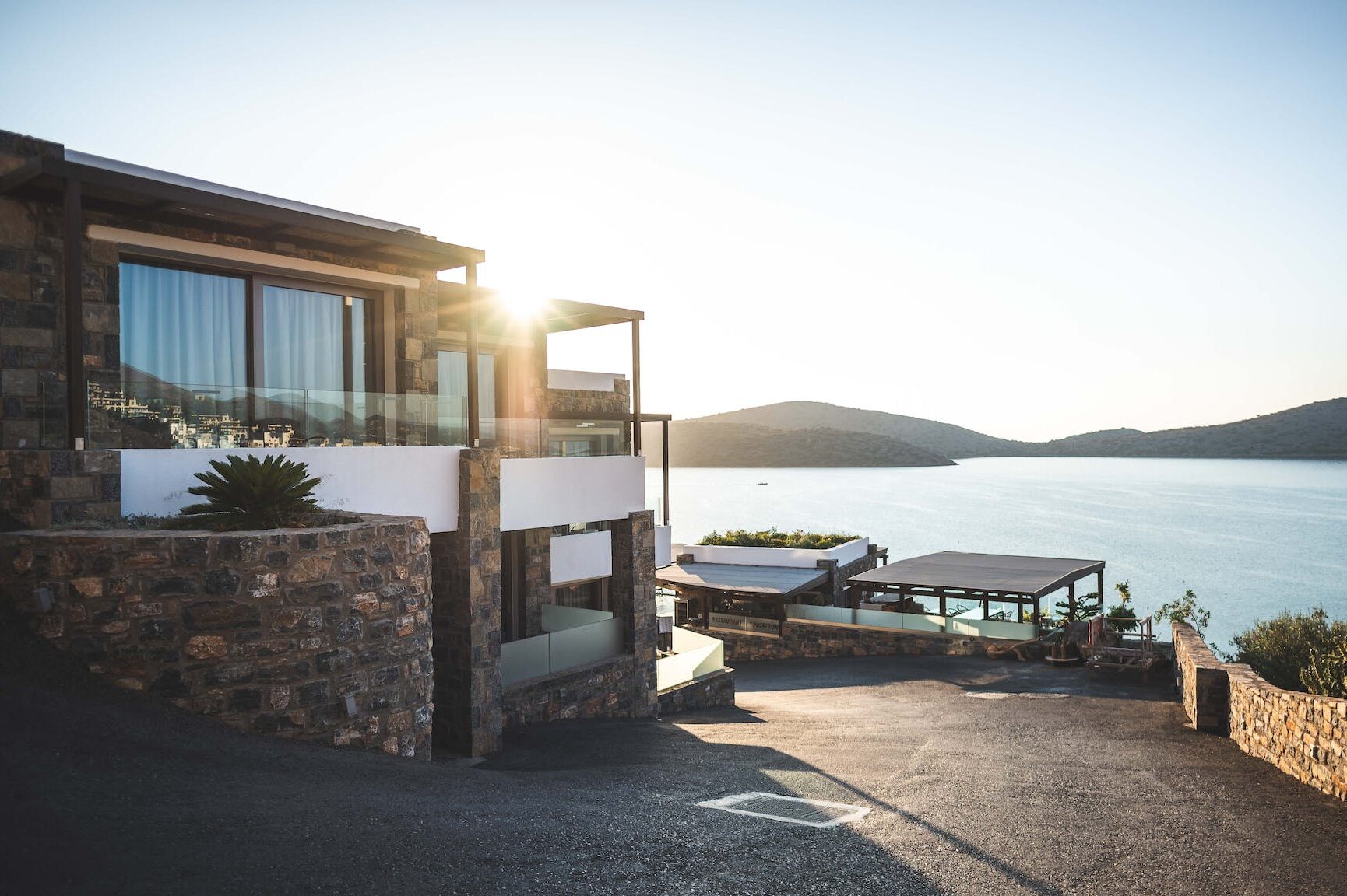 Sun Piercing of Brown Concrete House Near Sea